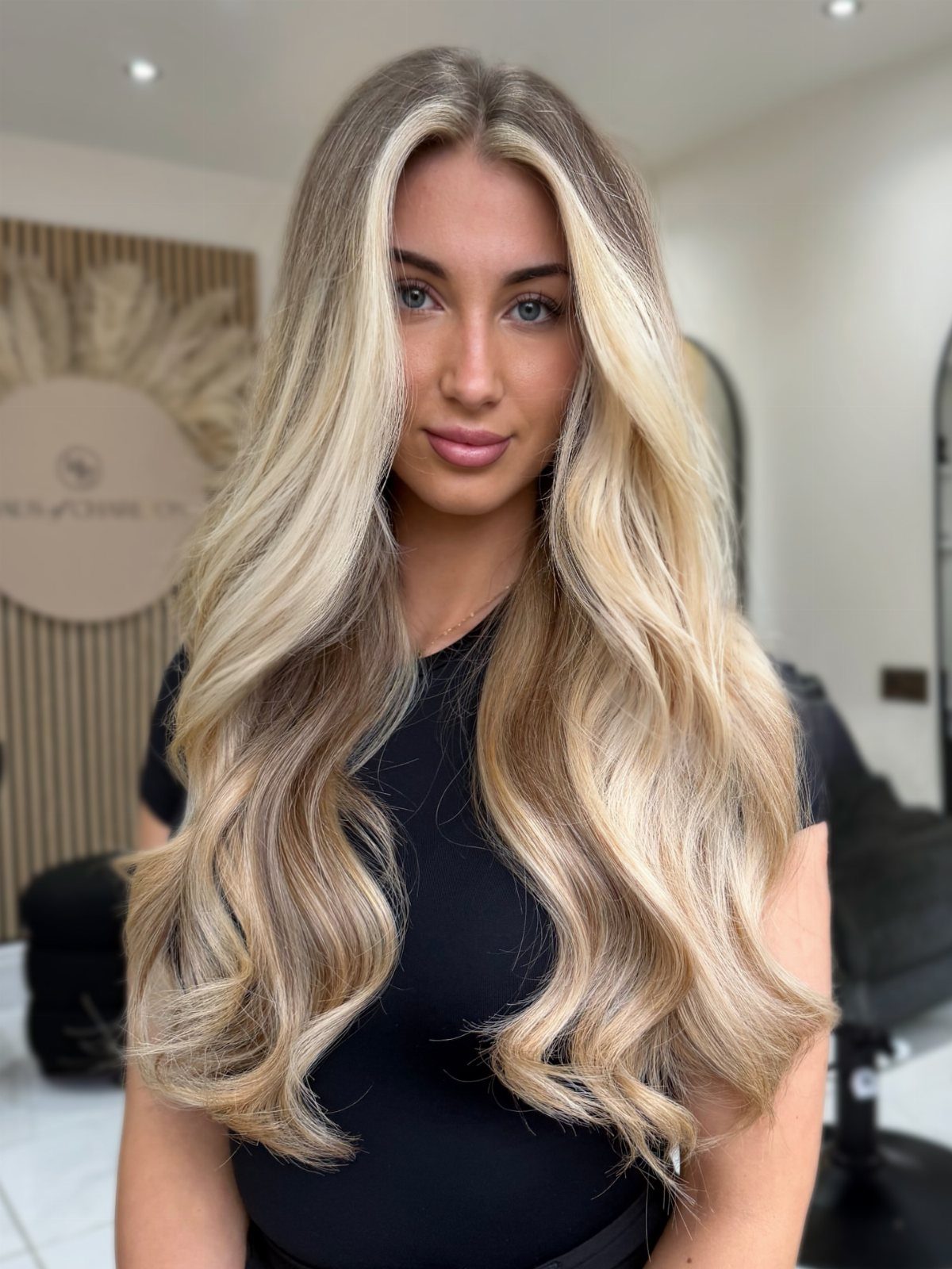 3 Color Hair Ideas: 15 Looks from Burnt Orange to Emerald 1 Woman with long wavy blonde hair and bright blonde highlights framing her face.