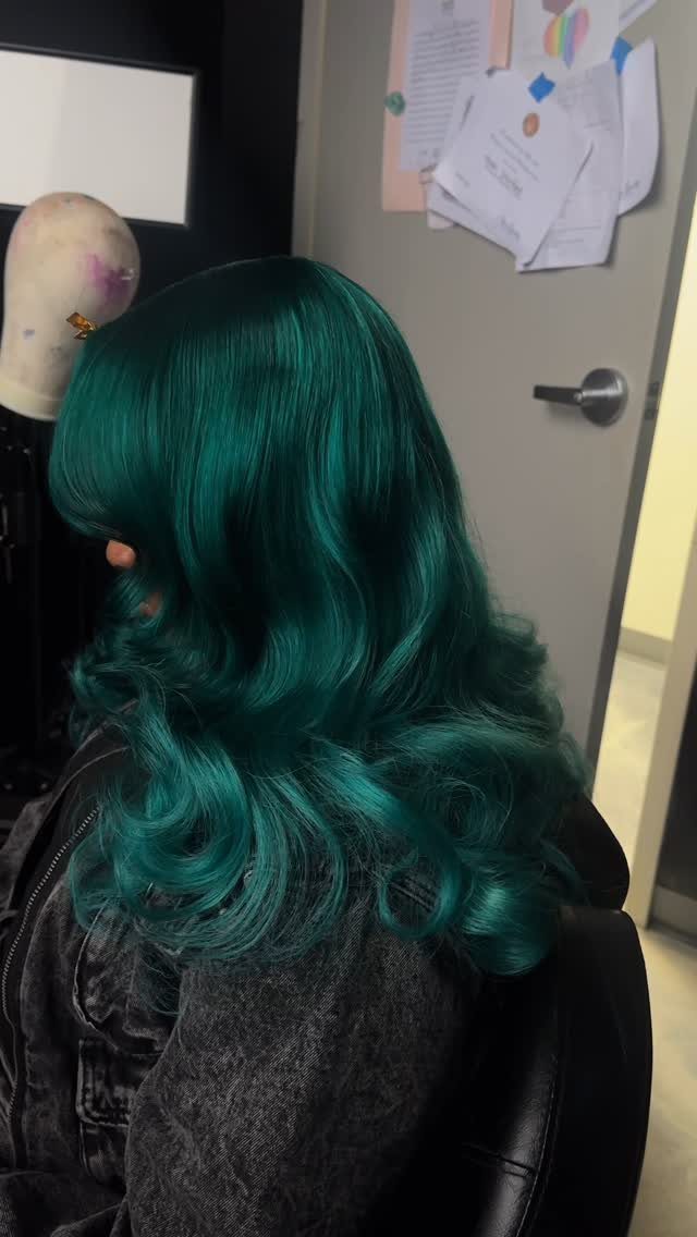 3 Color Hair Ideas: 15 Looks from Burnt Orange to Emerald 14 Long wavy emerald green hair on a person wearing a grey denim jacket.