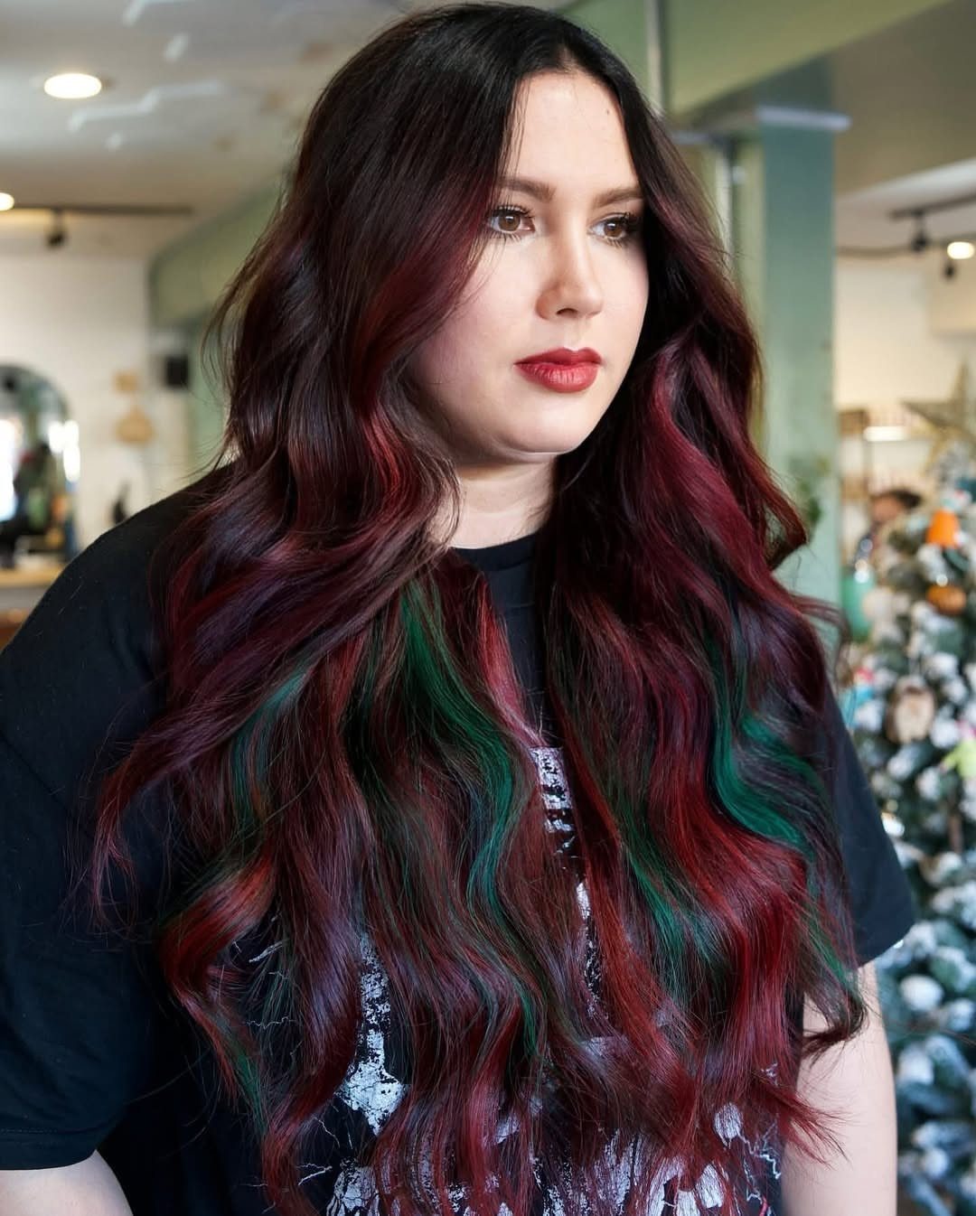 3 Color Hair Ideas: 15 Looks from Burnt Orange to Emerald 10 Woman with long wavy red hair featuring bright green tips and burgundy tones.