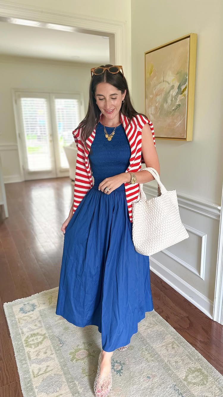 Woman in a long blue sundress, striped shirt, and clear high heels.