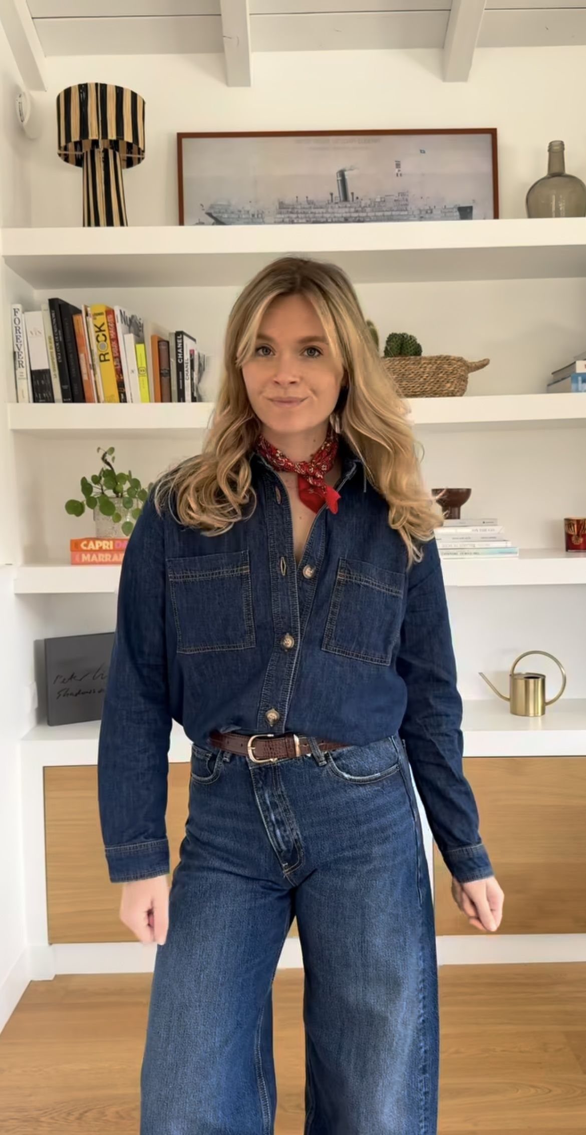 8 Outfit Ideas for 90s Country Style with Denim 8 Woman wearing a dark denim shirt and wide-leg jeans with a red scarf.