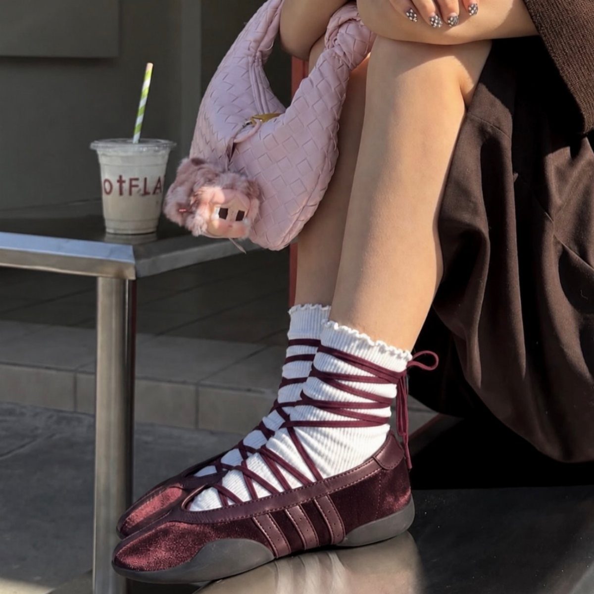 Adidas Taekwondo Ballerina Looks and Styles: 5 Ideas 2 Burgundy satin ballet sneakers with white laces worn over white socks outdoors.