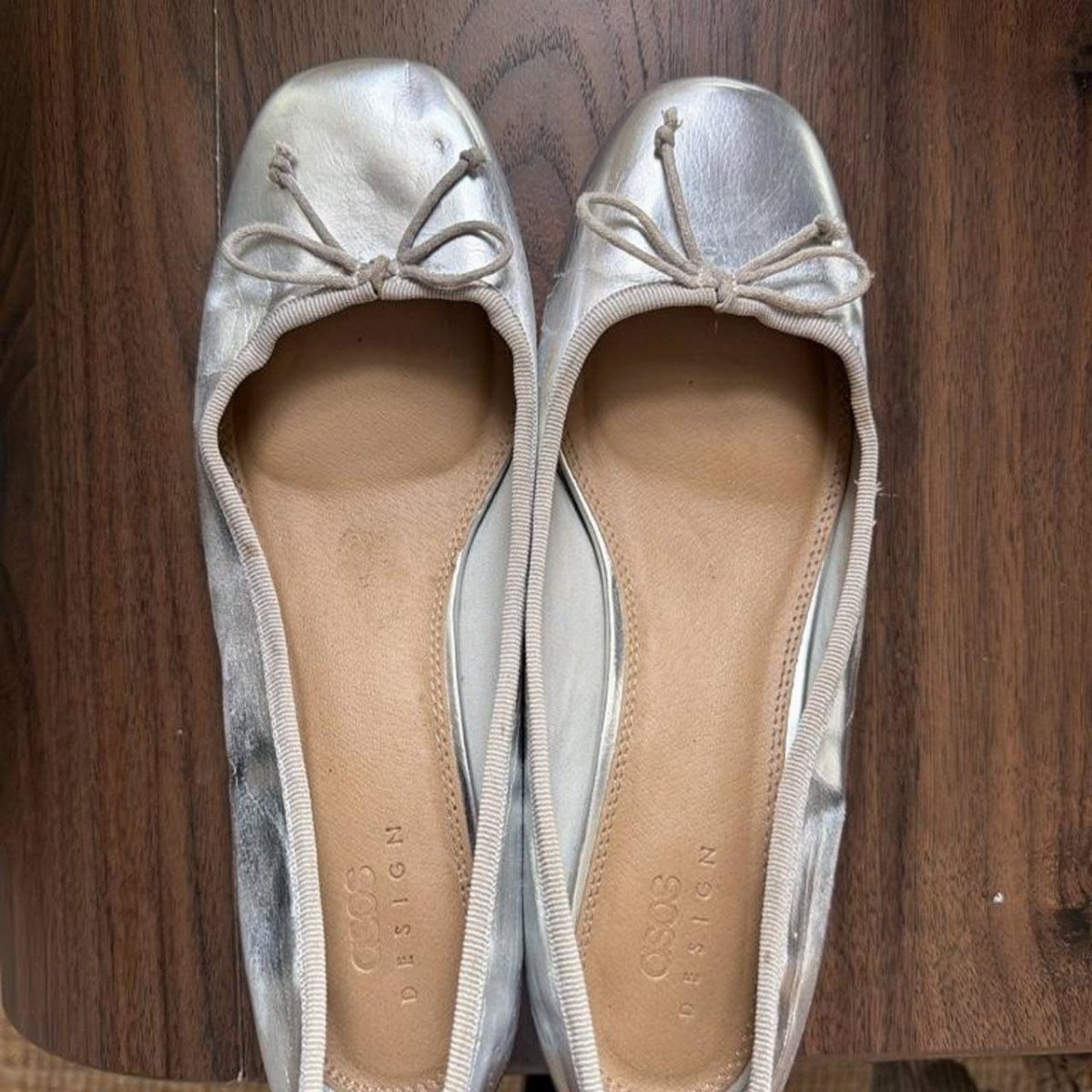 Adidas Taekwondo Ballerina Looks and Styles: 5 Ideas 3 Silver metallic ballet flats with small bows on a dark wooden background