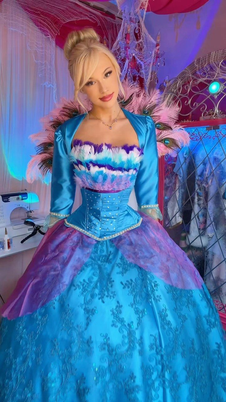 Woman in a deluxe blue and purple princess gown with feathered collar