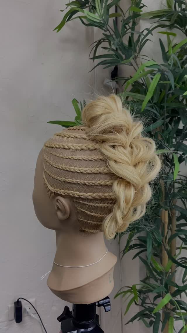 20 African Hair Styles Braids 18 Blonde braided faux hawk hairstyle on a mannequin head with green plant background