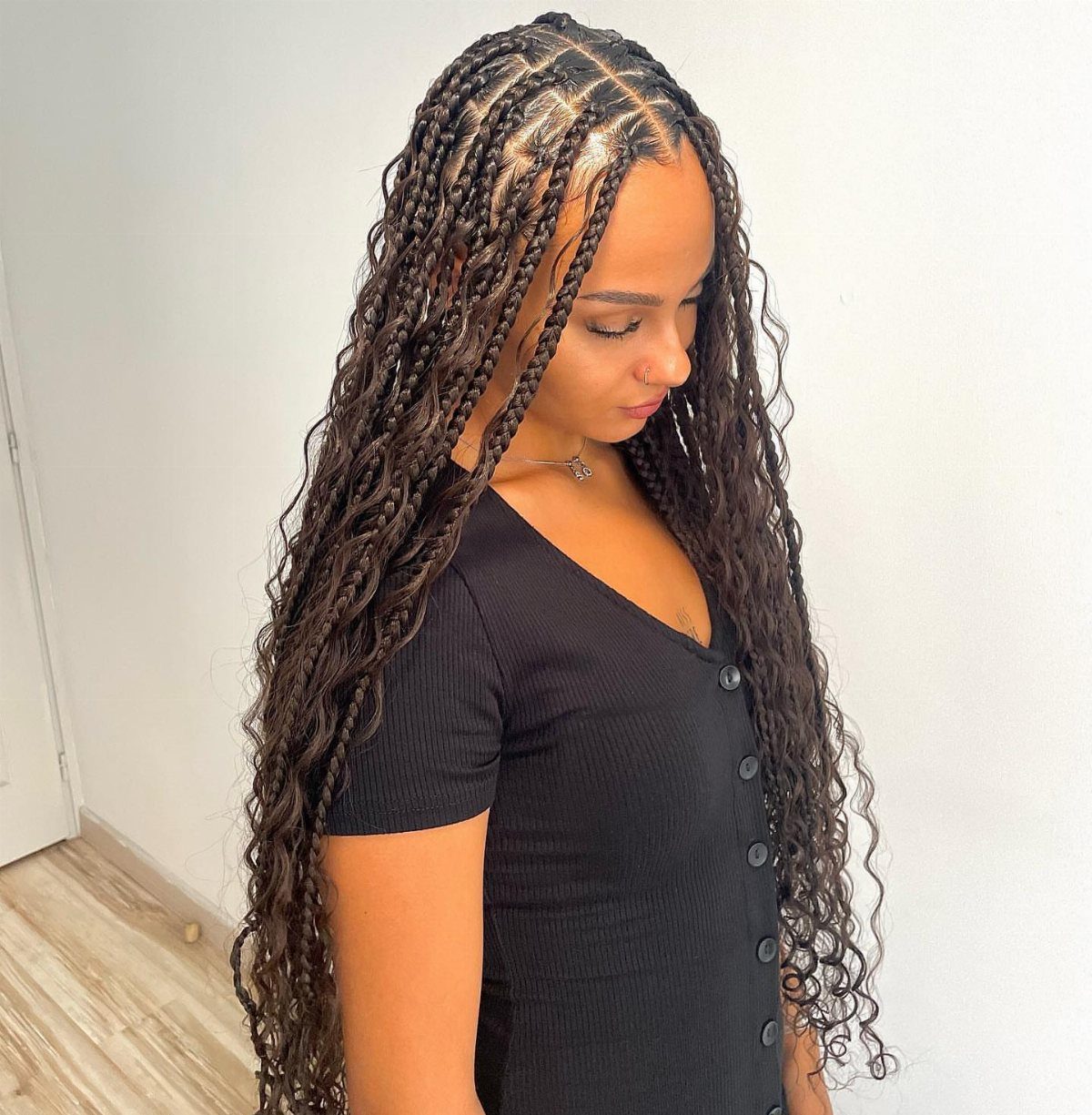 20 African Hair Styles Braids 2 Woman with long dark brown goddess braids with curly ends and loose curls.