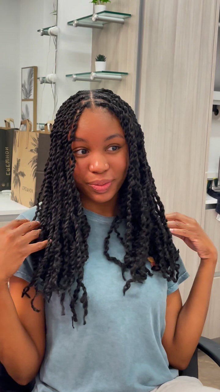 20 African Hair Styles Braids 8 Woman with long dark passion twists hair style wearing a light blue t-shirt