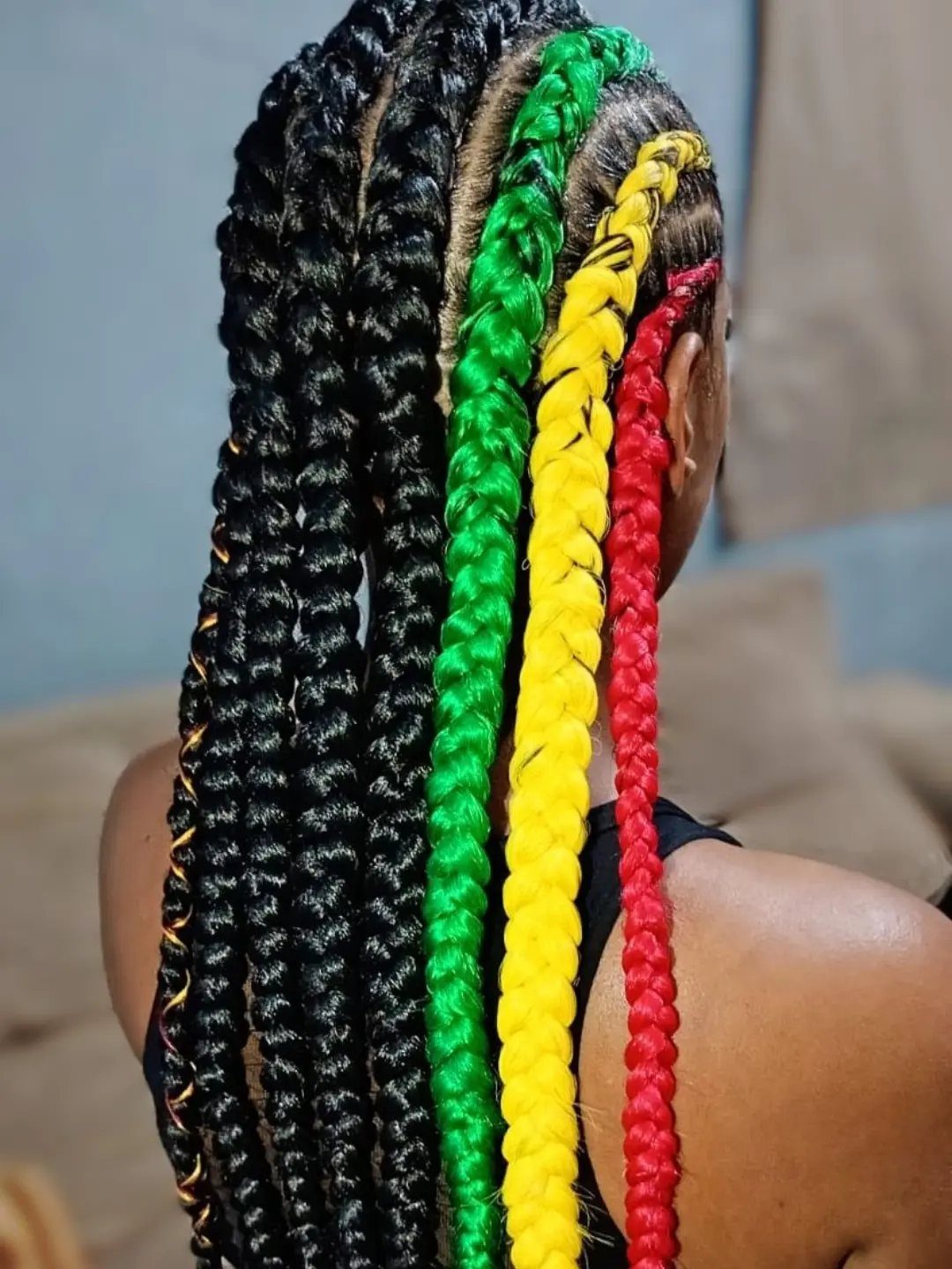 20 African Hair Styles Braids 19 Long box braids with black, green, yellow, and red colorful strands.