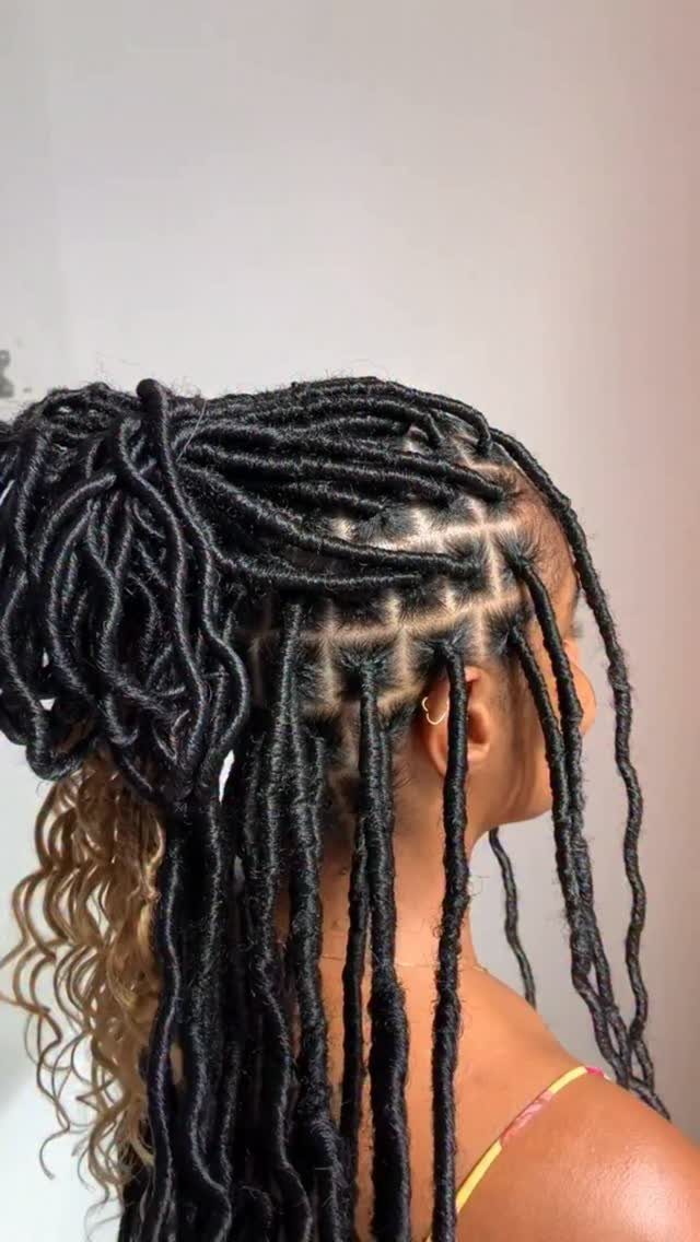 Afro Hair 4c Style Ideas: 19 Looks From Cornrows to Locs 9 Person with long black faux locs styled in a high ponytail.