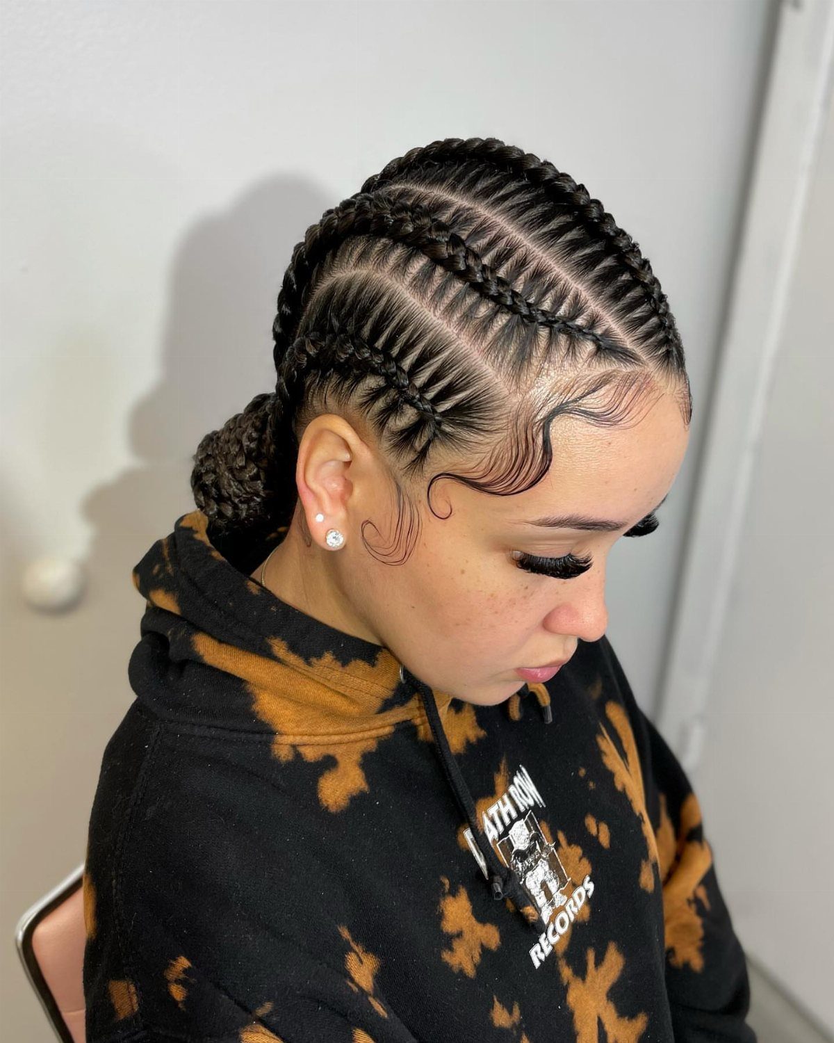 Afro Hair 4c Style Ideas: 19 Looks From Cornrows to Locs 12 Woman with French braided hair gathered into a low bun and styled edges.