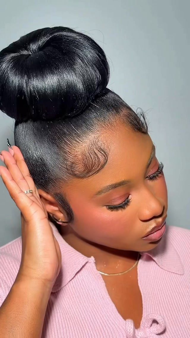 Afro Hair 4c Style Ideas: 19 Looks From Cornrows to Locs 18 Woman with a sleek, polished high bun and styled edges wearing pink clothing.