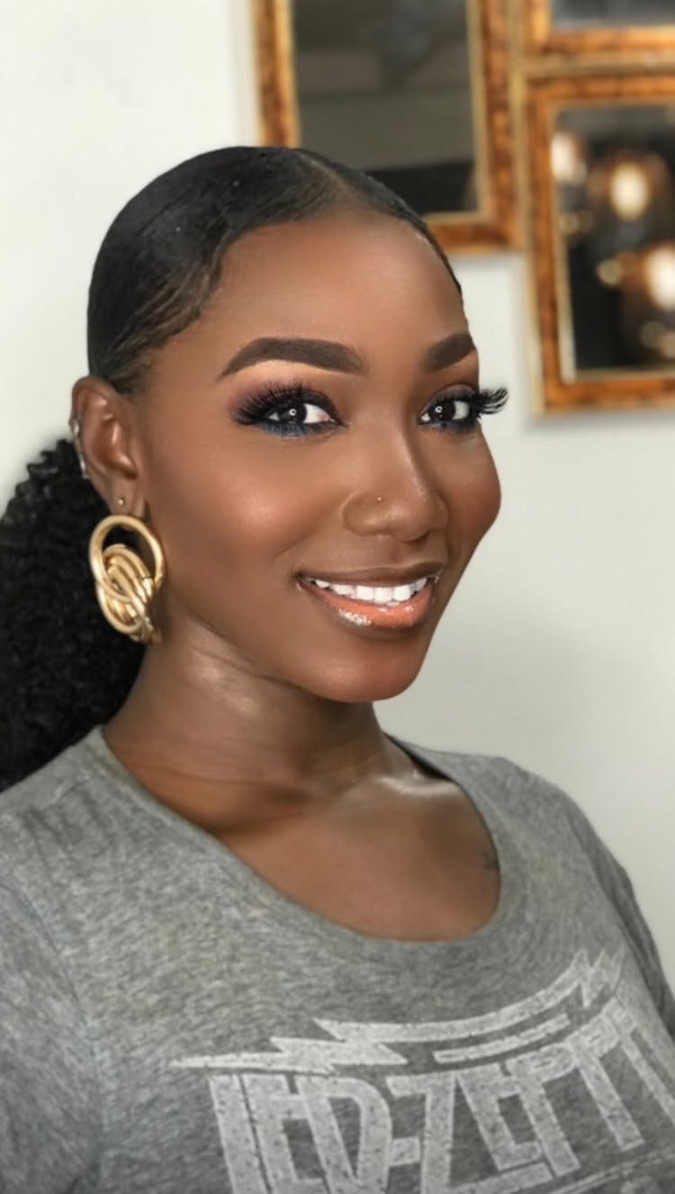 Afro Hair 4c Style Ideas: 19 Looks From Cornrows to Locs 19 Woman with slicked back hair tied into a low ponytail and gold earrings.