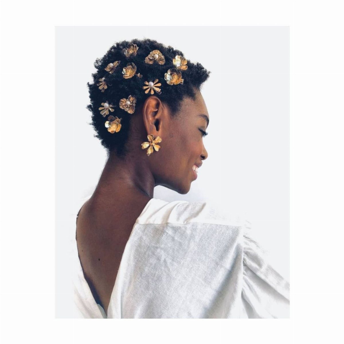 Afro Hair 4c Style Ideas: 19 Looks From Cornrows to Locs 15 Woman with short natural hair decorated with gold floral hair accessories and earrings.