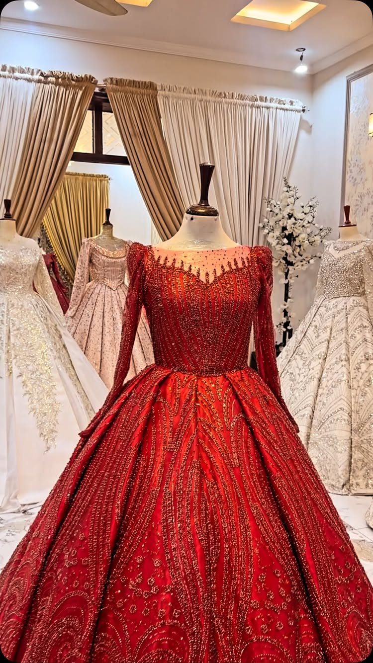Red beaded ball gown with a full skirt displayed on a mannequin.