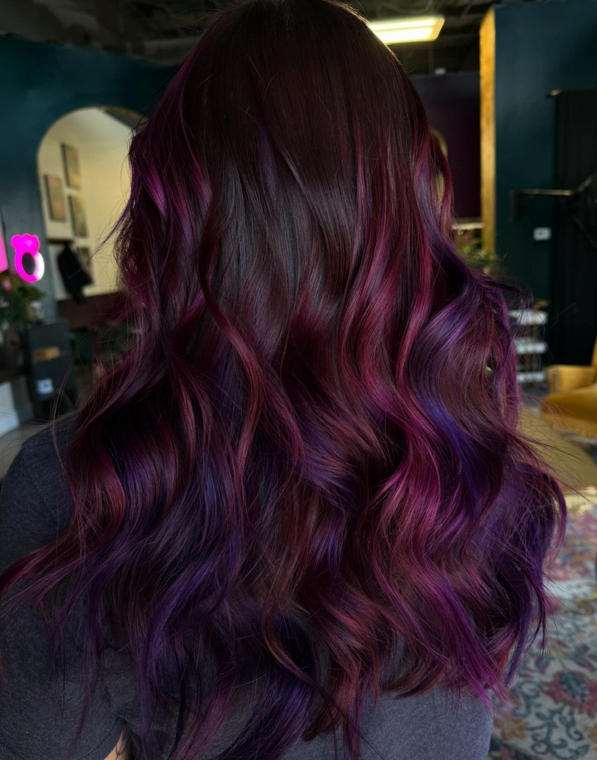 5 Black Cherry Hair Ideas for Deep, Glossy Color 2 Long wavy hair with deep burgundy and vibrant violet highlights from behind.