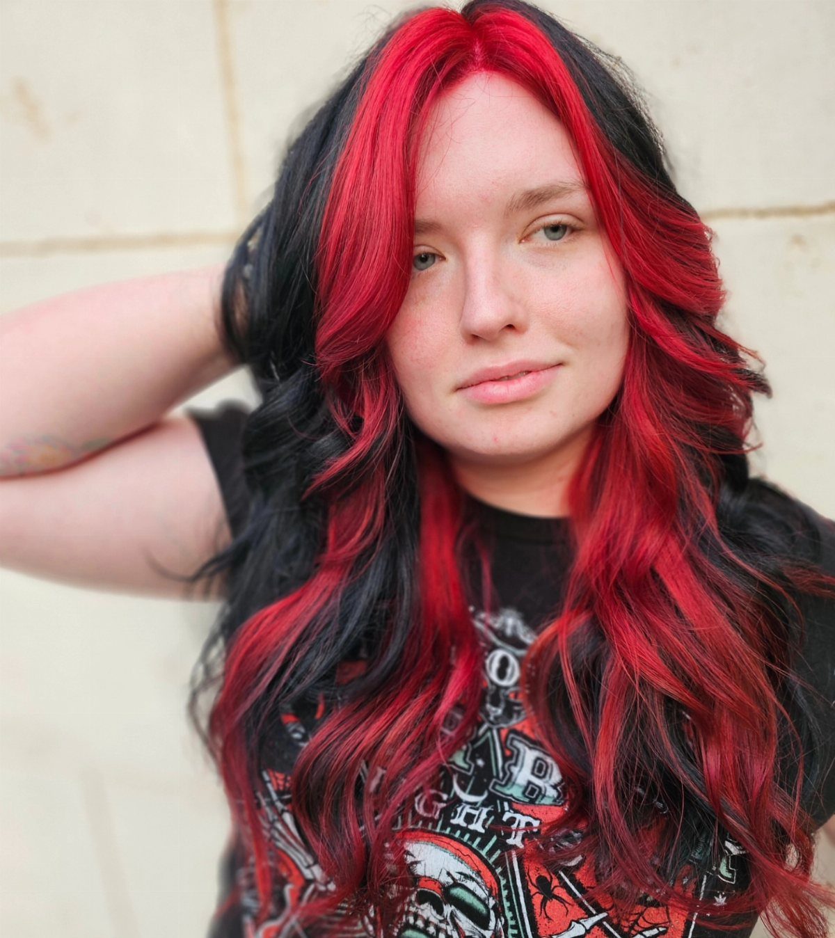 Woman with long wavy hair featuring bold blocks of black and red color.