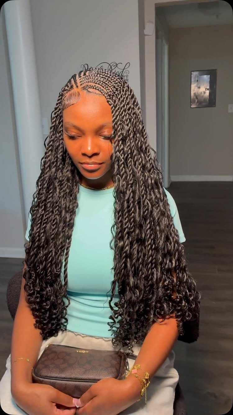 Woman with long dark cornrows and curly extensions reaching her waist