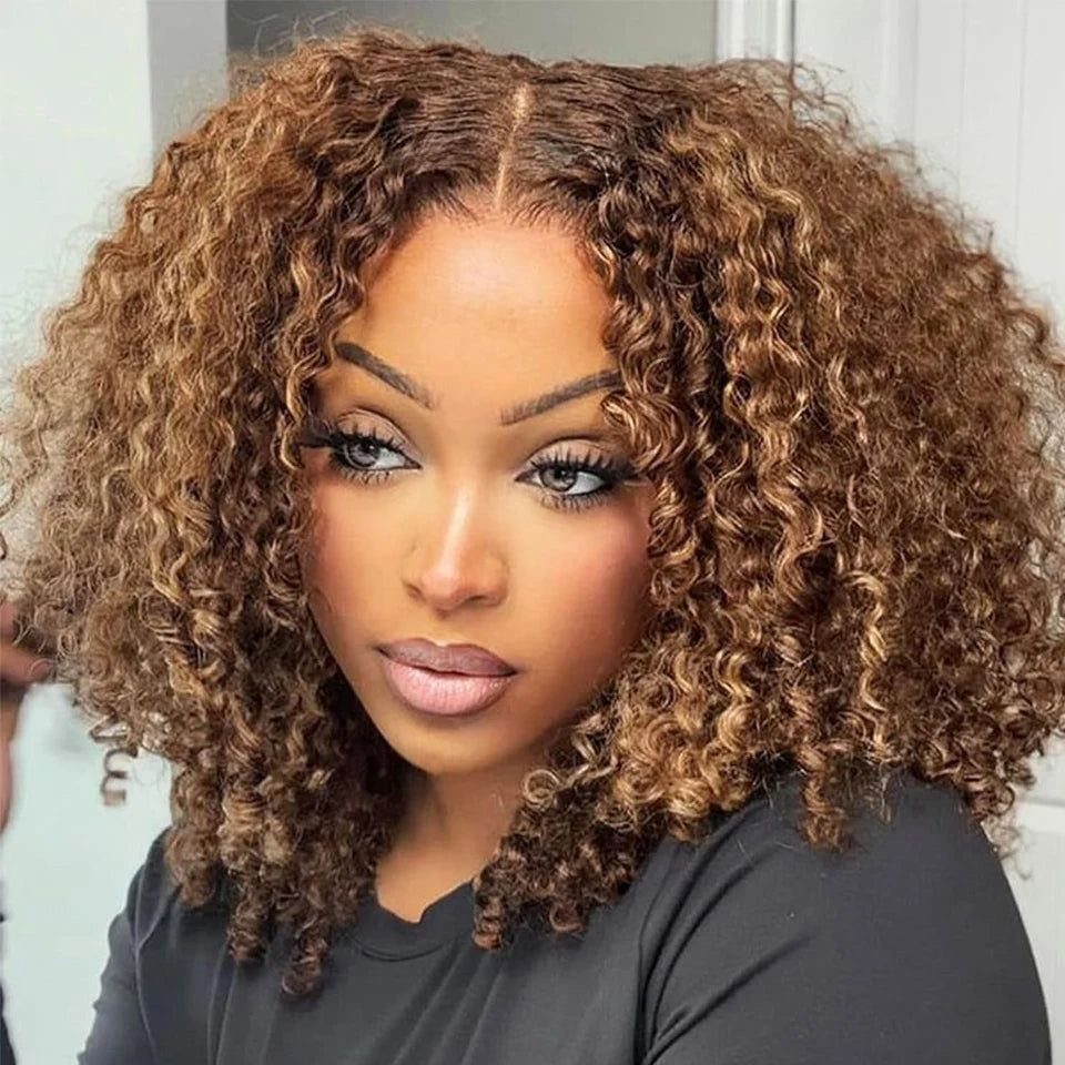 Woman with a highlighted curly bob hairstyle and spiral curls in brown and blonde.
