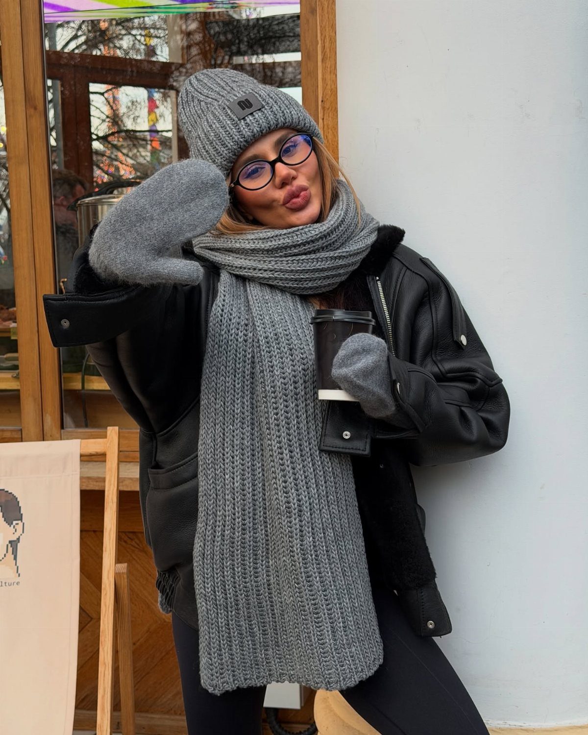 Cute Bonfire Outfits: 11 Ideas for Cozy Fall Nights 5 Woman wearing a grey knit beanie, scarf, and gloves with a leather jacket.