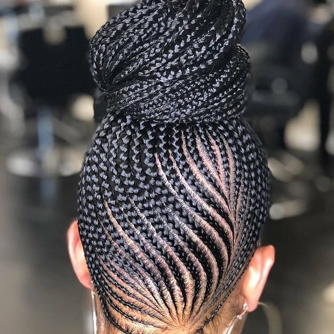Intricate cornrow braids leading into a large coiled braided bun on top.
