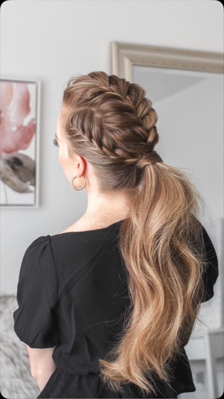 Woman with a blonde mohawk braid transitioning into a long low ponytail.