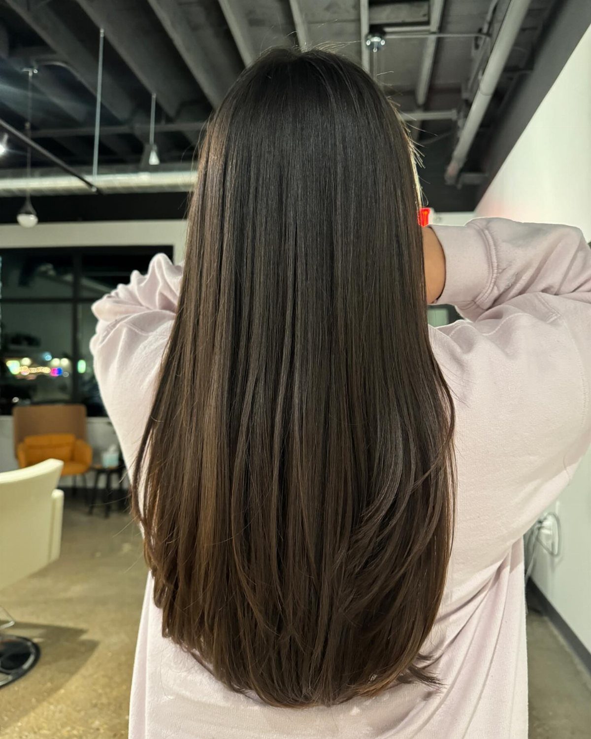 Long straight dark brown hair with rounded ends curved inward at the bottom.