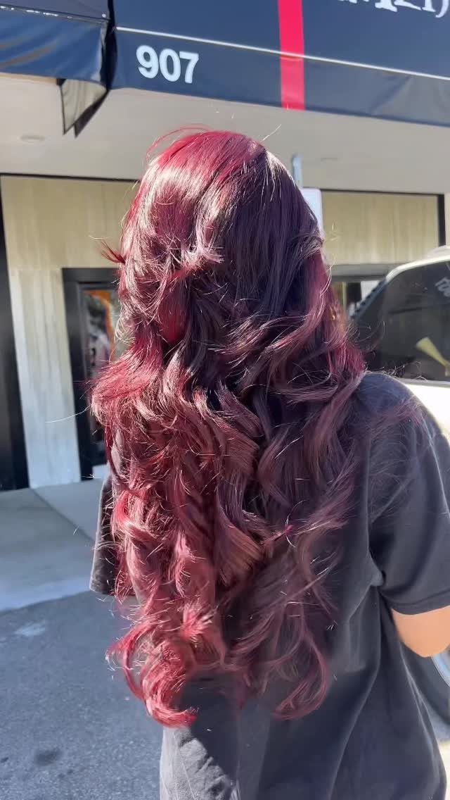 8 Deep Red Hair Dye Ideas for Every Cut and Texture 6 Long curly deep red hair seen from behind on a person outdoors.