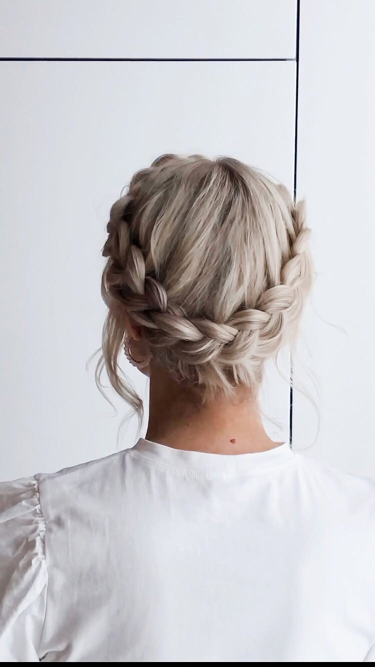 Blonde hair styled in a braided crown updo from a back view.