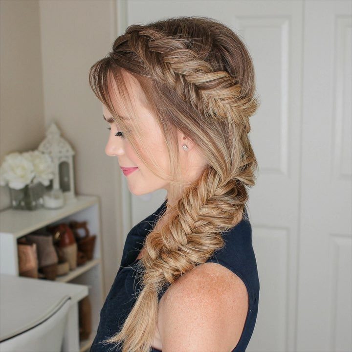 Woman with blonde hair styled in a detailed fishtail half updo braid.