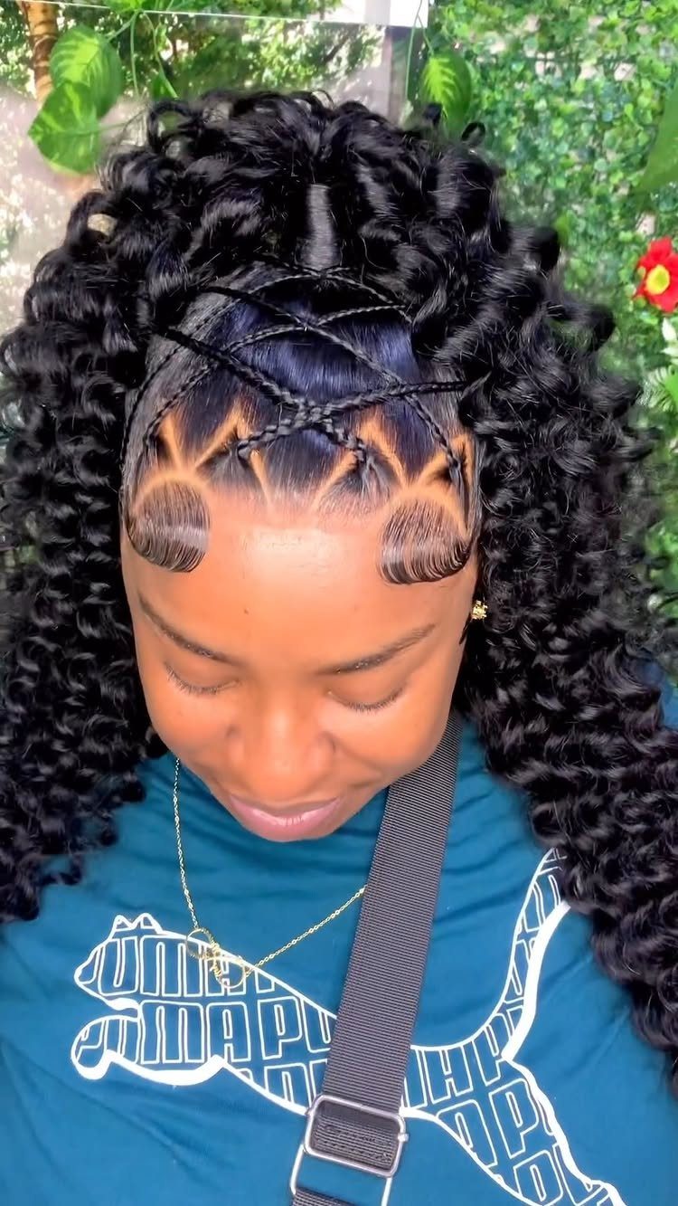 Woman with curly black hair in a high ponytail with braided front details.