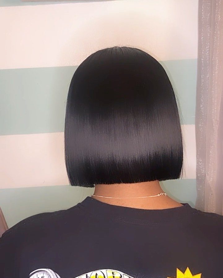 Sleek black mid-length hair in a blunt bob cut seen from behind.