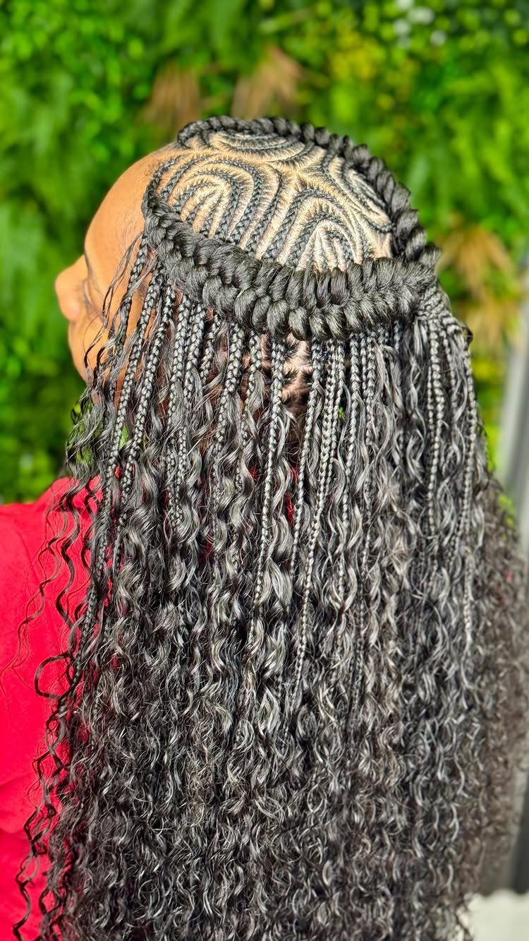 Woman with long curly braids and a braided halo crown over patterned scalp.