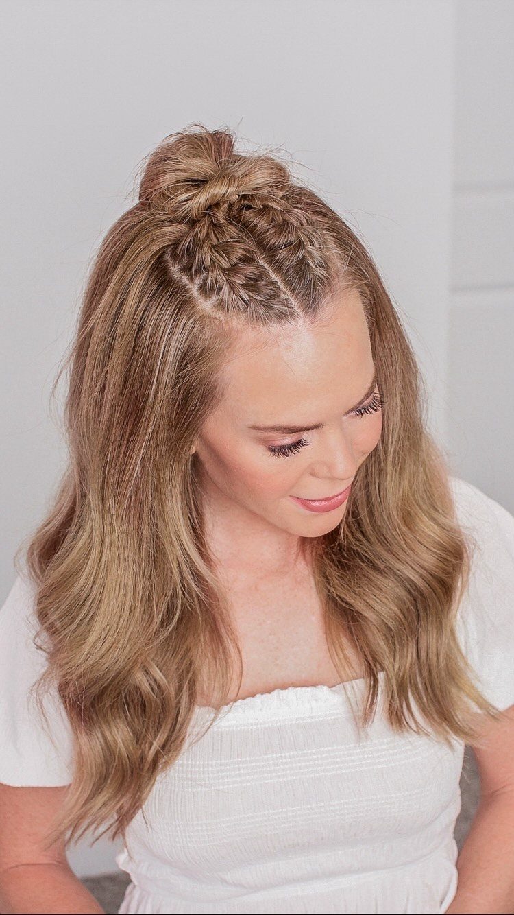 Woman with blonde hair in a half up half down bun with braids