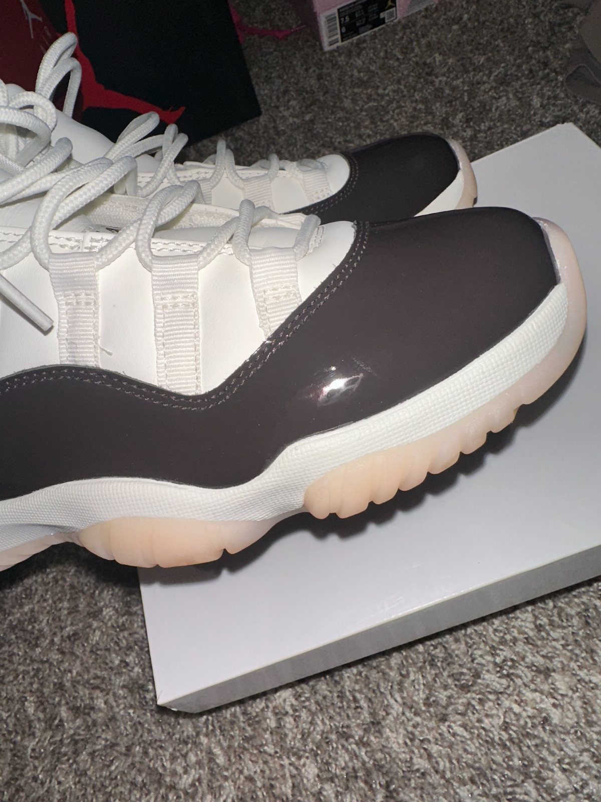 Air Jordan 11 Neapolitan sneakers with brown and white colors on a white box.