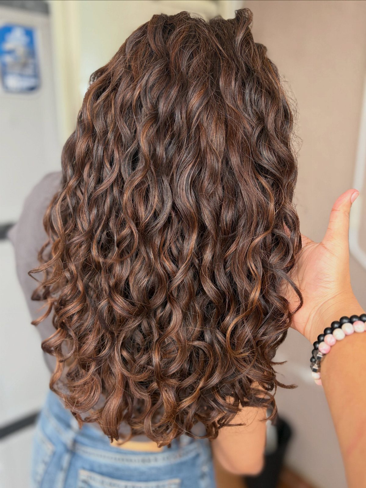 12 Long Brown Hair Ideas with Highlights, Curls and Layers 6 Long curly dark brown hair with volume and defined ringlets seen from behind.