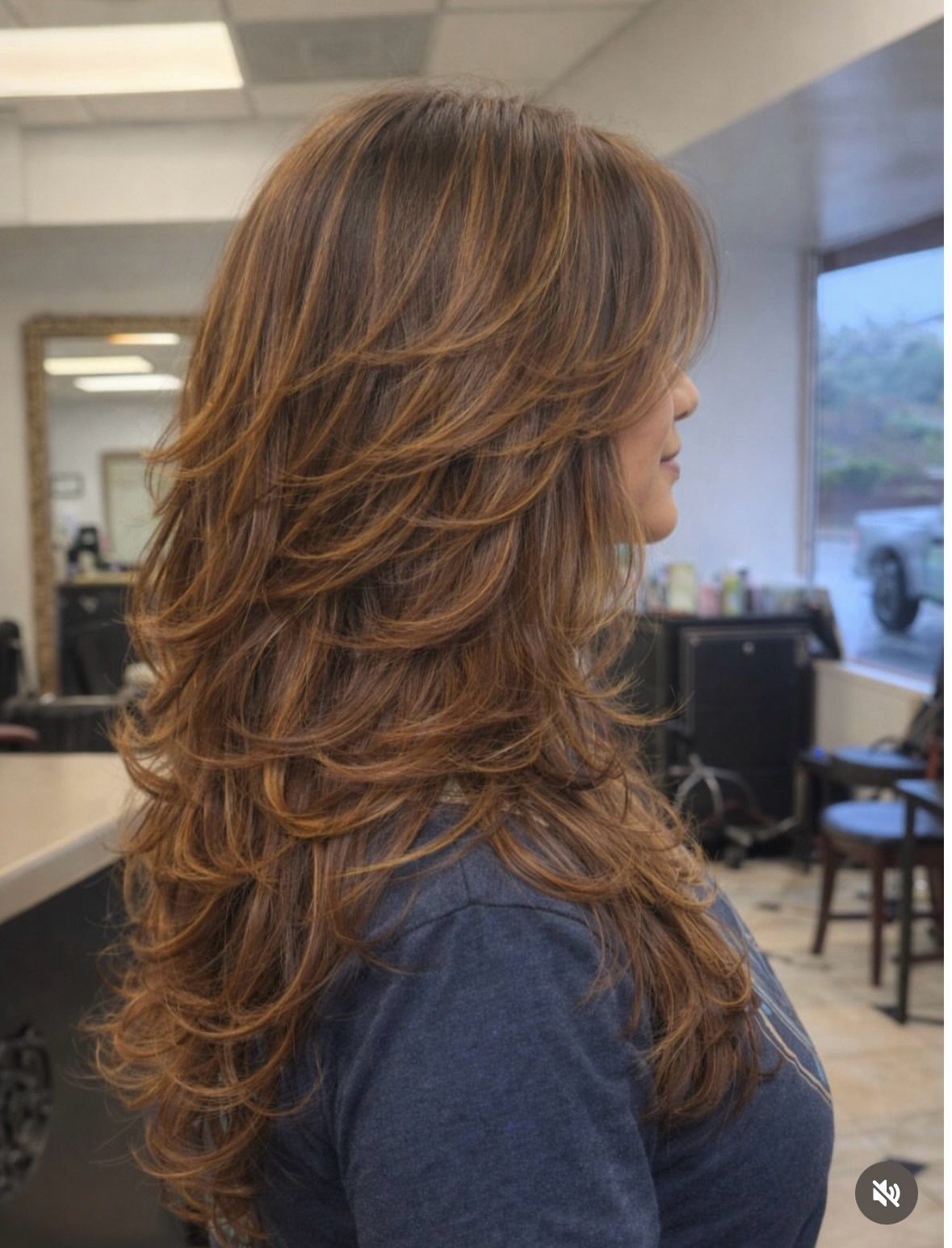 12 Long Brown Hair Ideas with Highlights, Curls and Layers 1 Long layered brown hair with caramel highlights and textured bangs in a salon.