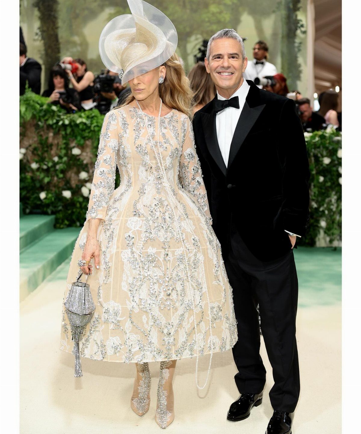 Sarah Jessica Parker in an embroidered beige gown and large white sculptural hat.