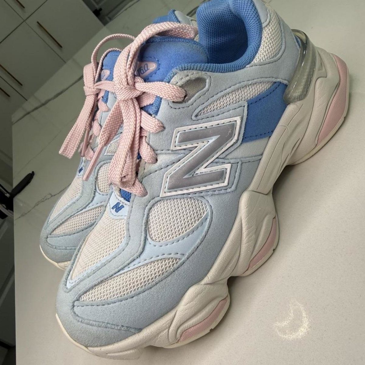 New Balance 9060 Pink and Blue Sneakers: 6 Ideas 1 Light blue and pink New Balance 9060 sneakers with a chunky white sole.