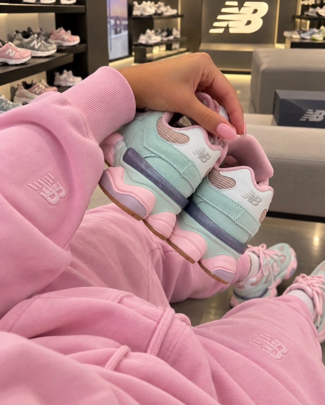 New Balance 9060 Pink and Blue Sneakers: 6 Ideas 5 Light blue and pink New Balance 9060 sneakers held by person in pink tracksuit