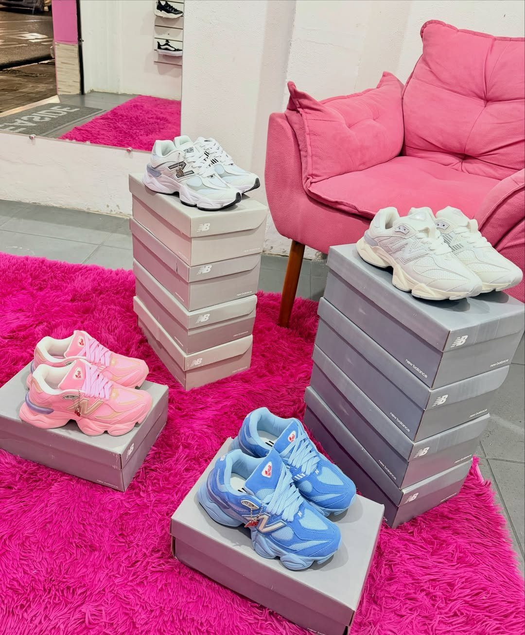 New Balance 9060 Pink and Blue Sneakers: 6 Ideas 4 New Balance 9060 sneakers in pink, blue, and white on a pink rug.