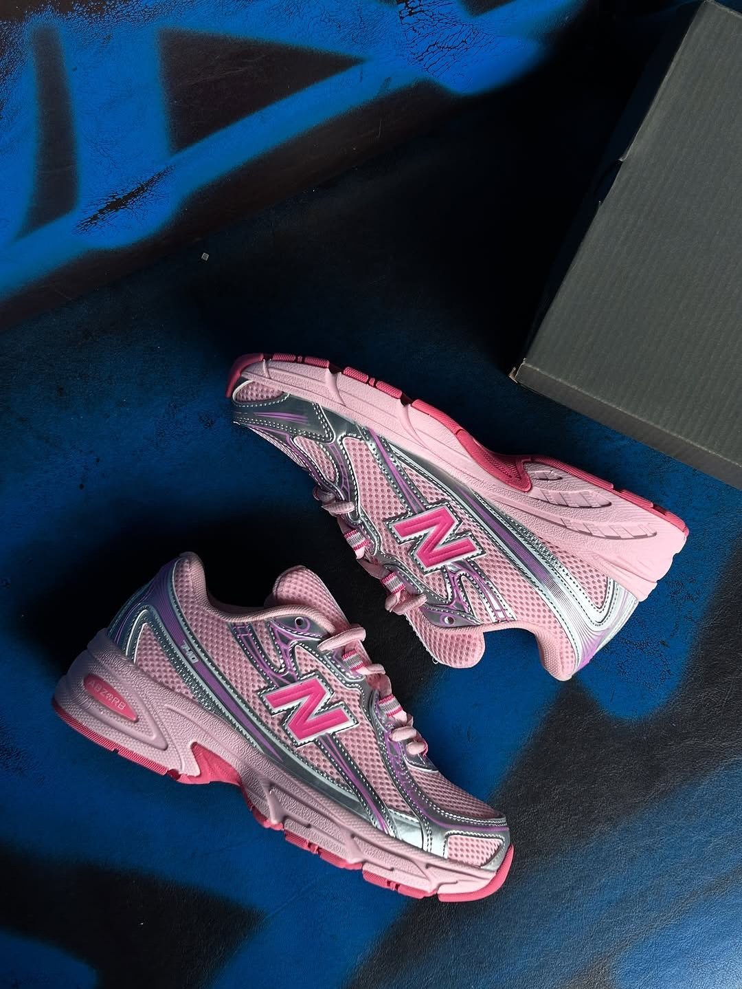 New Balance 9060 Pink and Blue Sneakers: 6 Ideas 6 New Balance 9060 sneakers in pink and iridescent blue on a graffiti background