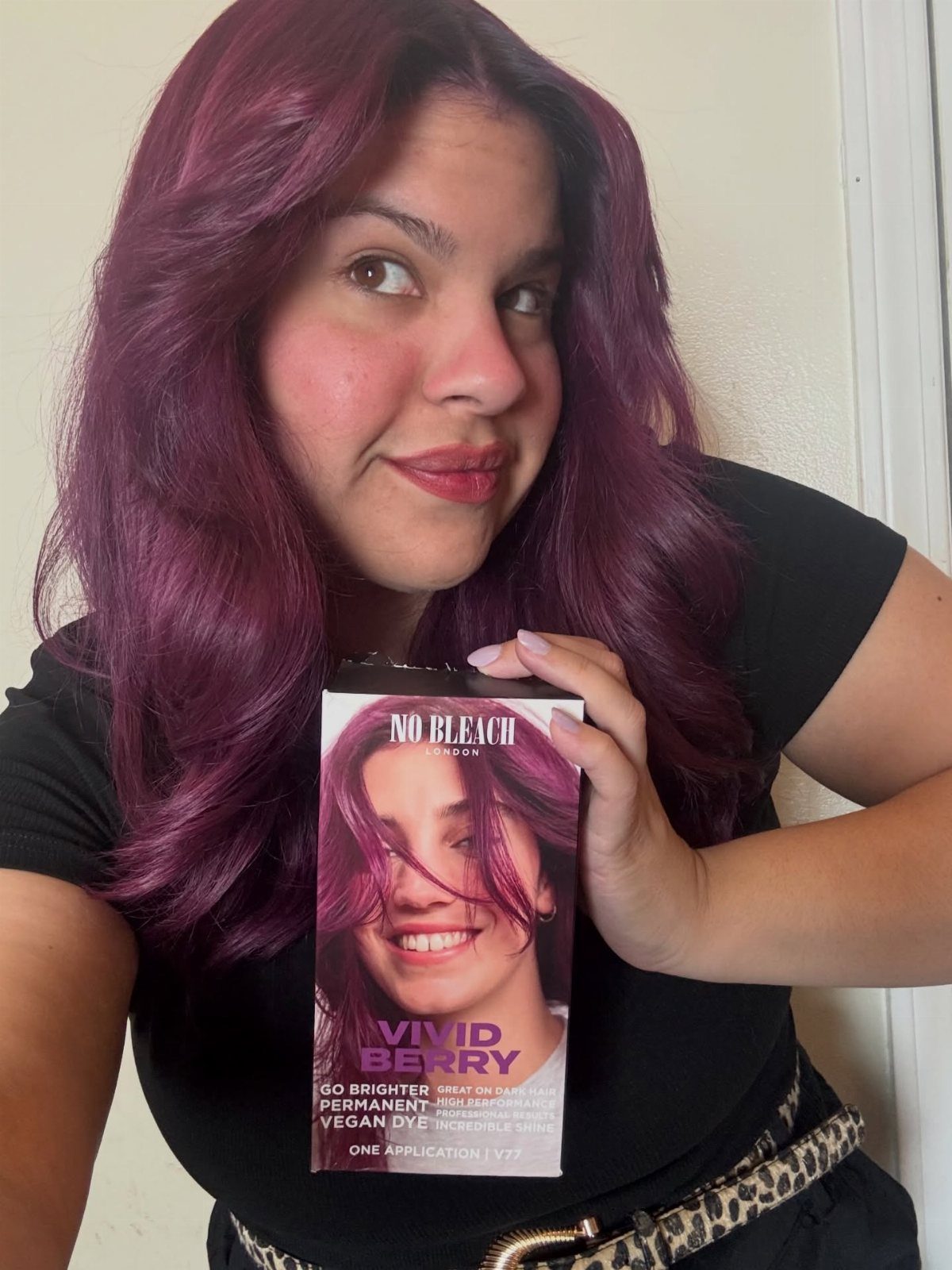 5 No Bleach London Vivid Berry Hair Color Ideas 2 Woman with berry-purple hair holding a box of No Bleach London hair dye.