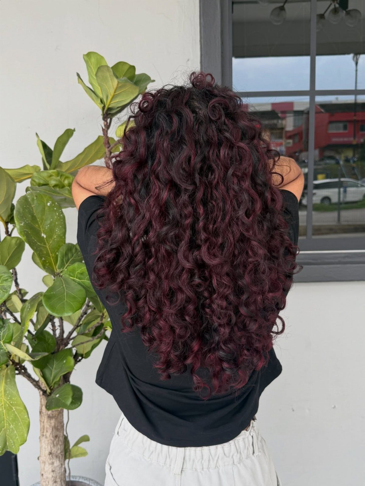 Oxblood Hair Color Ideas: 5 Looks for Every Length 5 Long curly oxblood red hair on a person seen from behind.