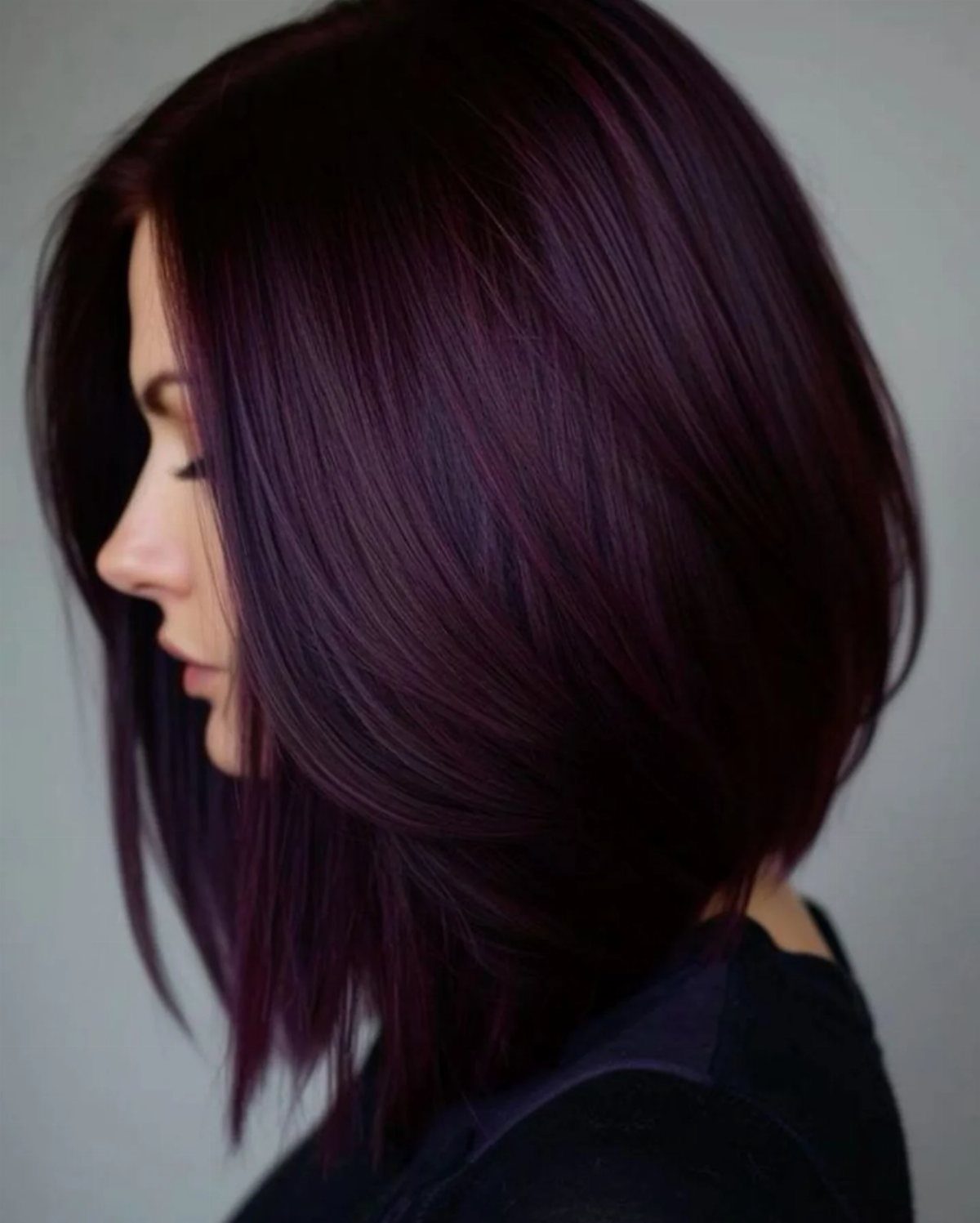Oxblood Hair Color Ideas: 5 Looks for Every Length 4 Woman with a sleek angled bob in deep oxblood red-purple hair color.