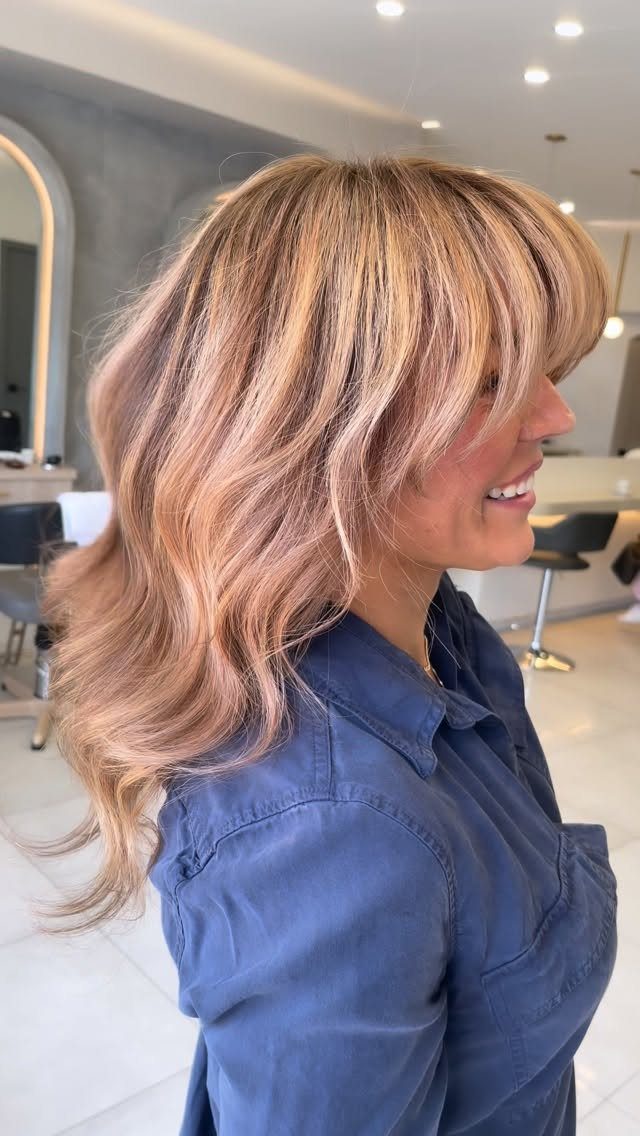 13 Red Undertones Hair Ideas, From Copper to Burgundy 13 Woman with wavy rose gold hair featuring pink and golden blonde highlights.