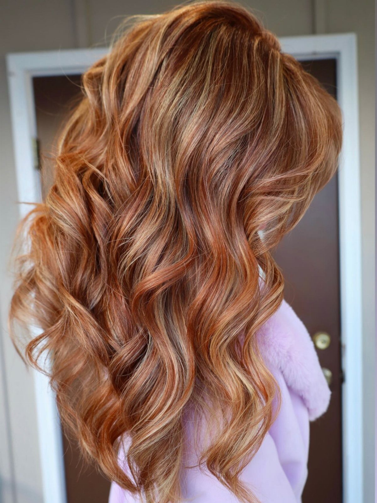 13 Red Undertones Hair Ideas, From Copper to Burgundy 3 Long wavy hair with a blend of golden blonde and copper red tones.