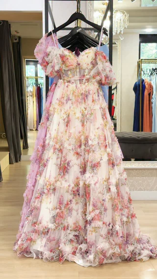 8 Rio Prom Dress Ideas for Florals, Sequins and Mermaid Cuts 1 Floral print chiffon maxi dress with puff sleeves and ruffled skirt on hanger