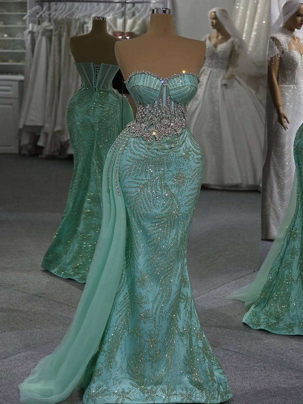 8 Rio Prom Dress Ideas for Florals, Sequins and Mermaid Cuts 8 Mint green sequined mermaid dress with a sheer cape on a mannequin