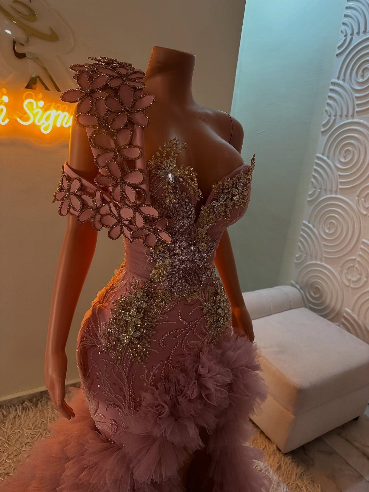 8 Rio Prom Dress Ideas for Florals, Sequins and Mermaid Cuts 2 Pink mermaid gown with gold sequins and floral shoulder detail on a mannequin