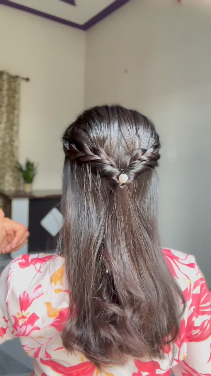 8 Simple Half Up Hairstyles for Every Occasion 5 Half-updo hairstyle with crisscrossed braids secured by a small white pearl clip.